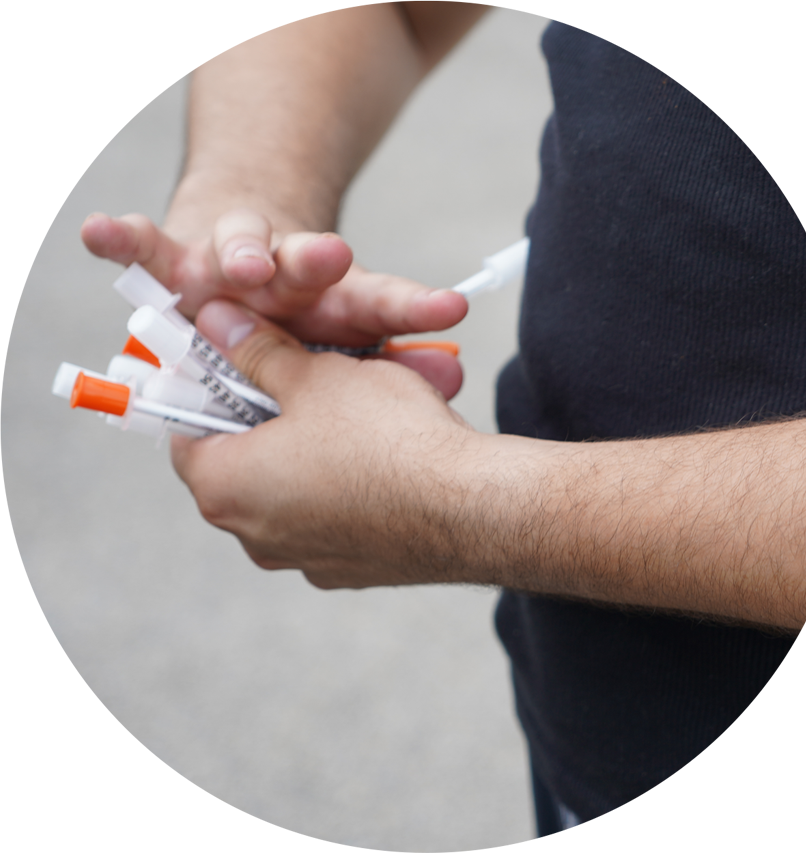 person holding syringes